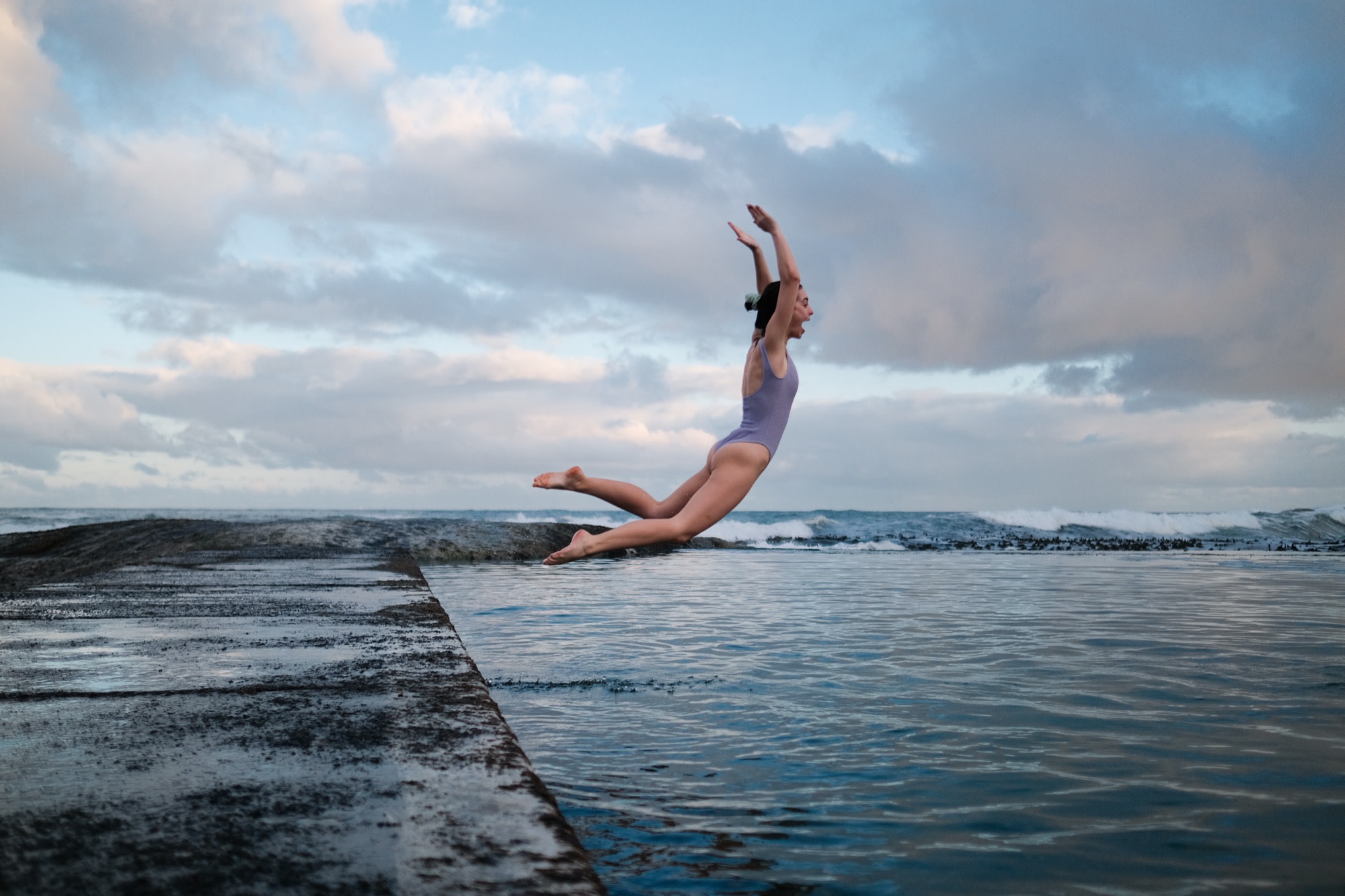 A leap into a sea pool at dawn