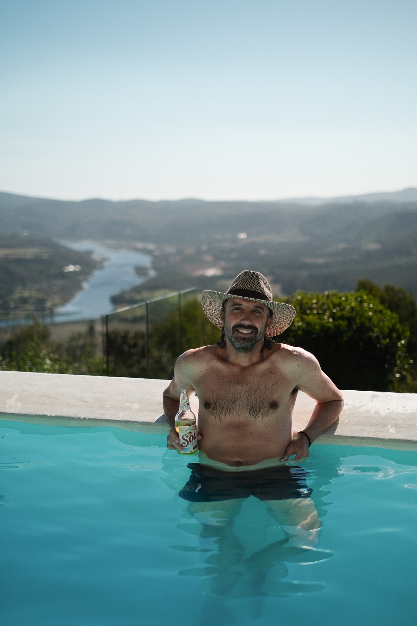 A cold one in the pool with a valley view