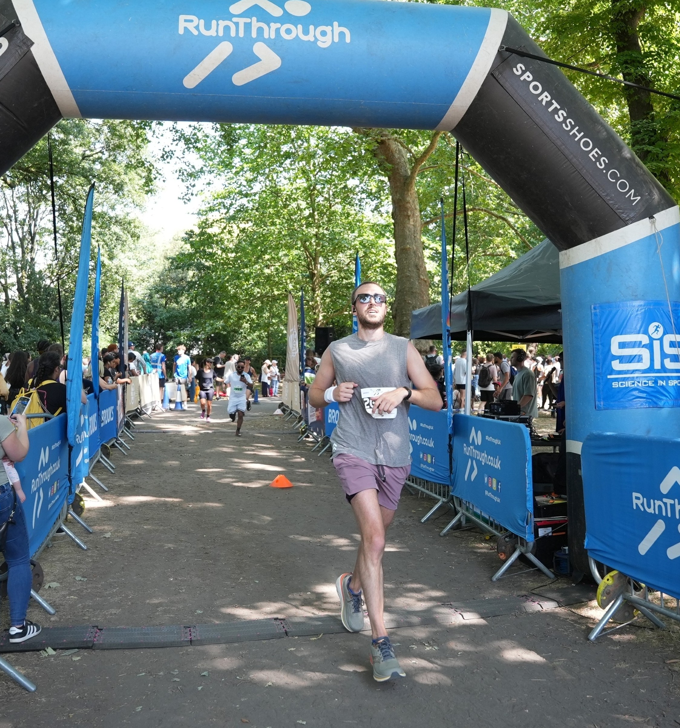 Kurtis crossing the finish line at Battersea Half Marathon