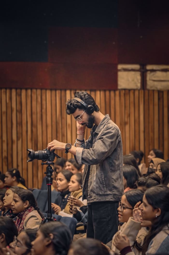 Ayushman operating a camera during a live production