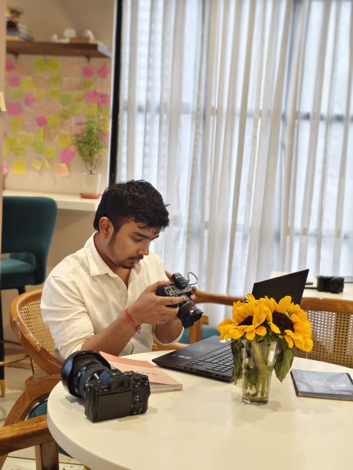 Adarsh reviewing footage during a production shoot