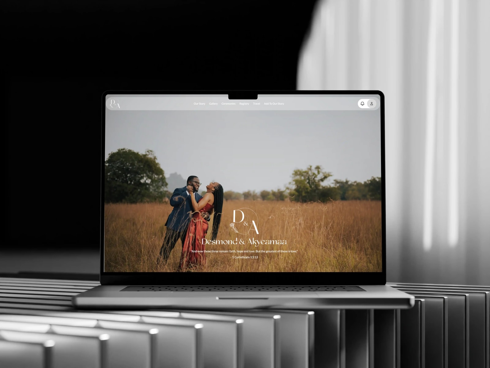 The Desmond Weds Akyeamaa homepage on a laptop: the couple in a golden field under the D&A monogram
