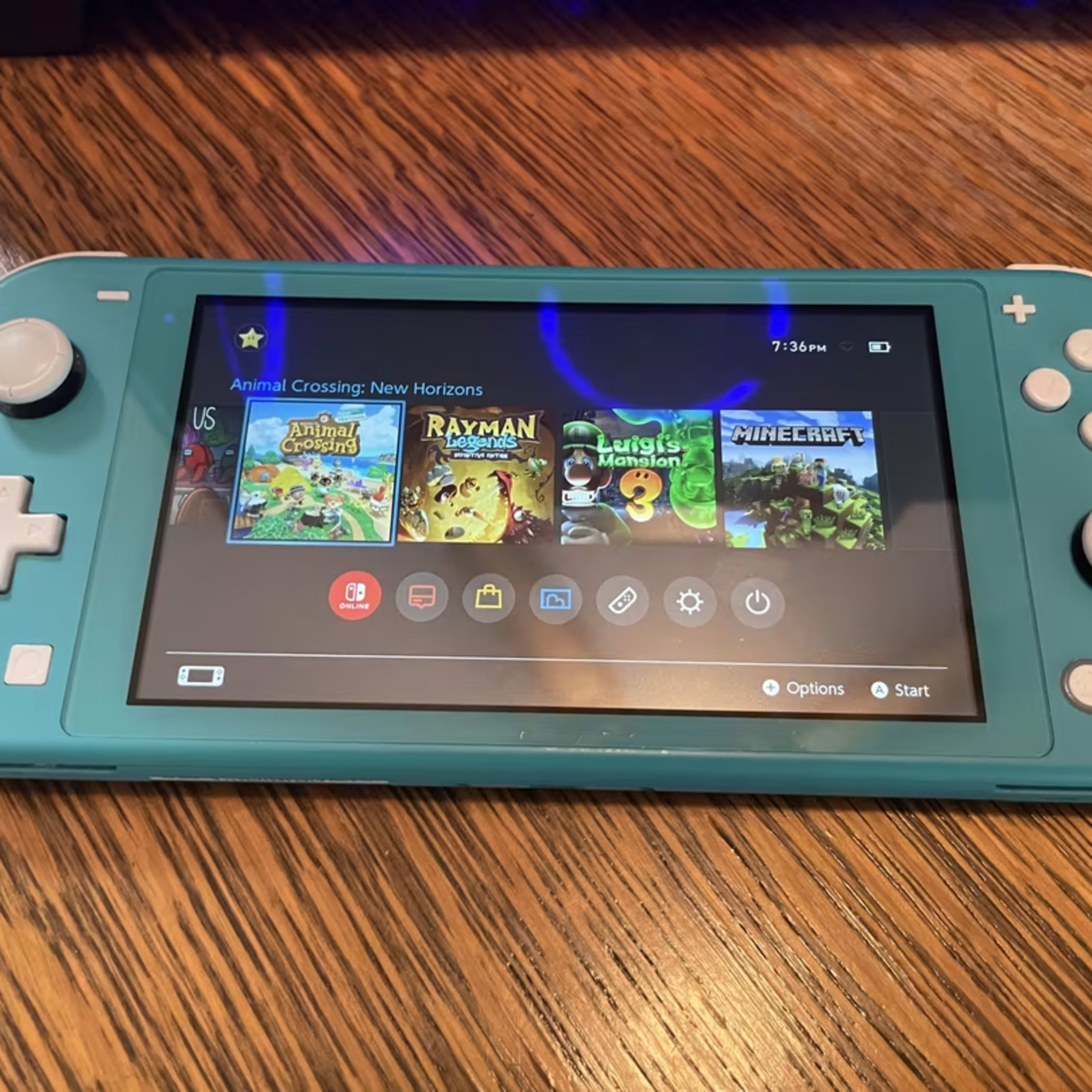 Turquoise Nintendo Switch Lite w/ loaded 128GB microSD + case