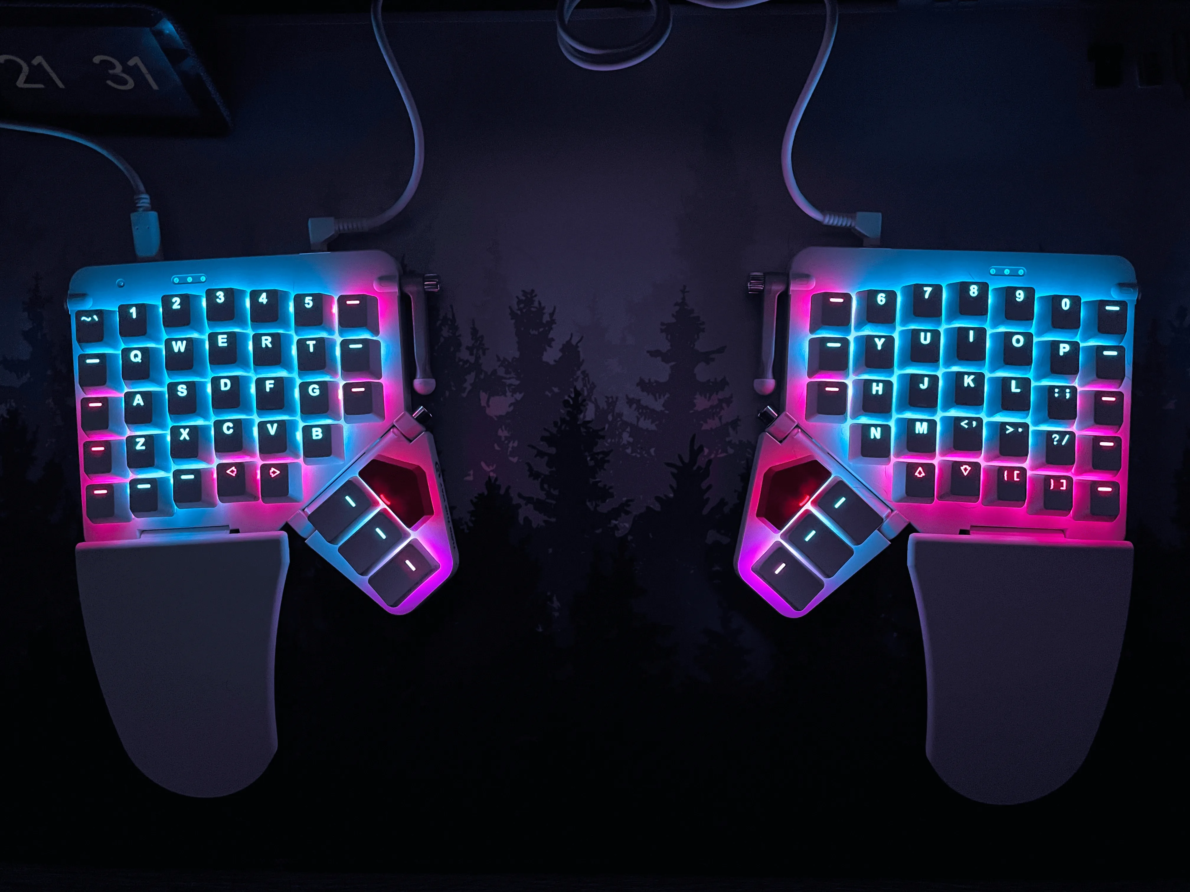 An picture of the Moonlander keyboard from above where the RGB keycap lighting is the sole light source