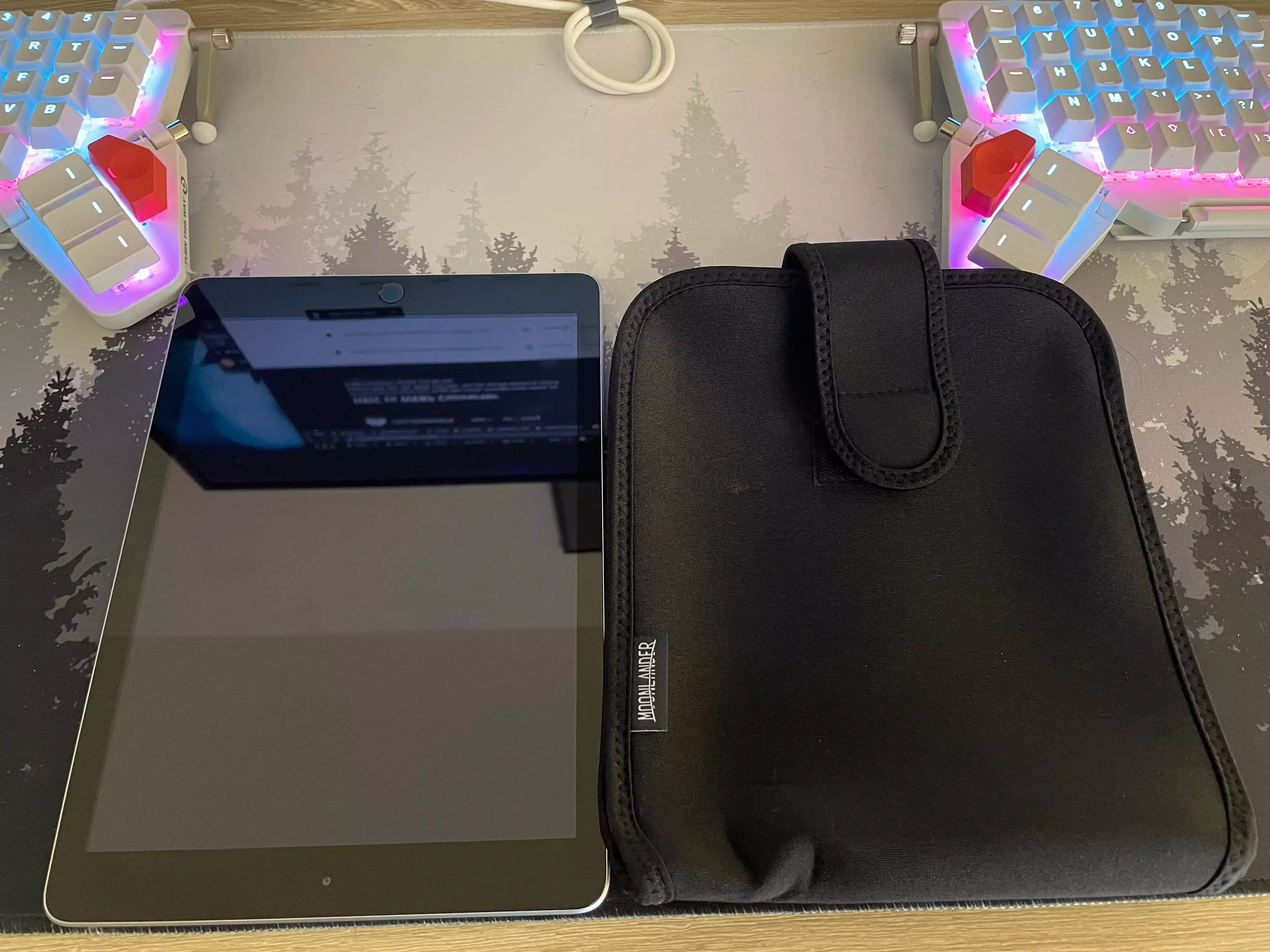 The Moonlander travel case size as compared to a 9.7inch iPad showing them as roughly the same size