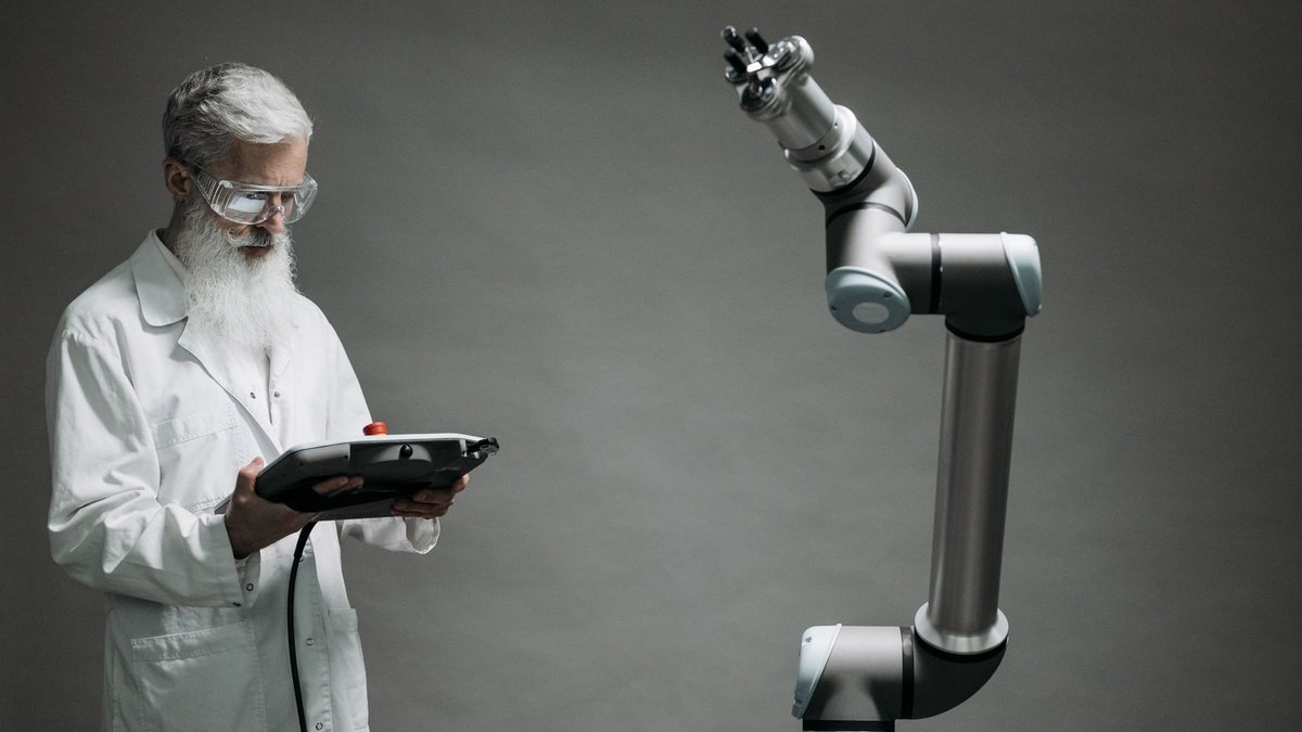 LAU Medical Center introduces advanced robotic surgery program A scientist in a lab coat operates a high-tech robotic arm in a laboratory setting.