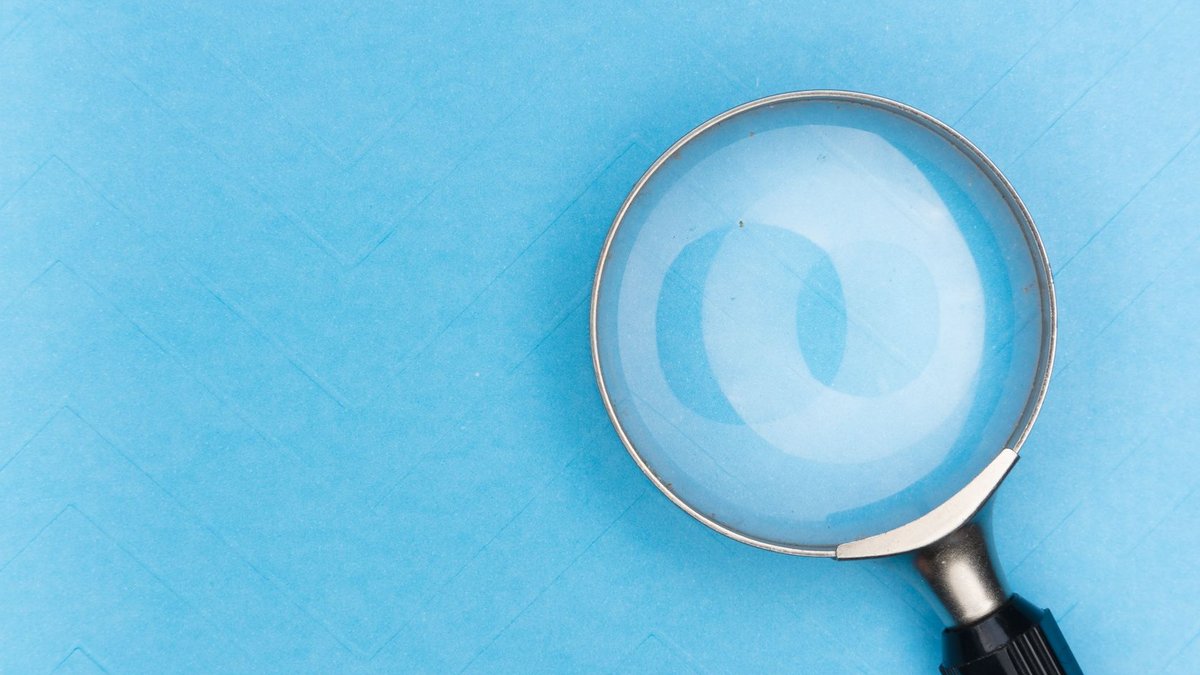 Google Adds Image Filter to Search Console Aiding Ecommerce Discovery Close-up of a magnifying glass on a blue surface, ideal for search and exploration themes.