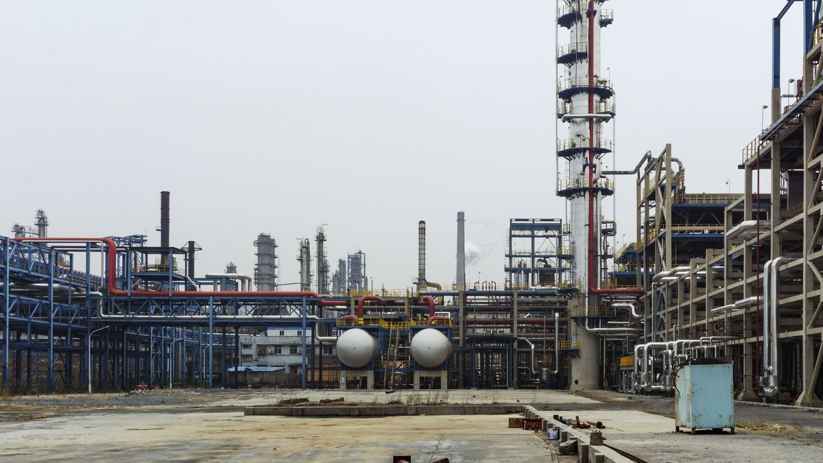 Dangote refinery project begins in Kenya A detailed view of an industrial refinery featuring pipelines and large steel structures.