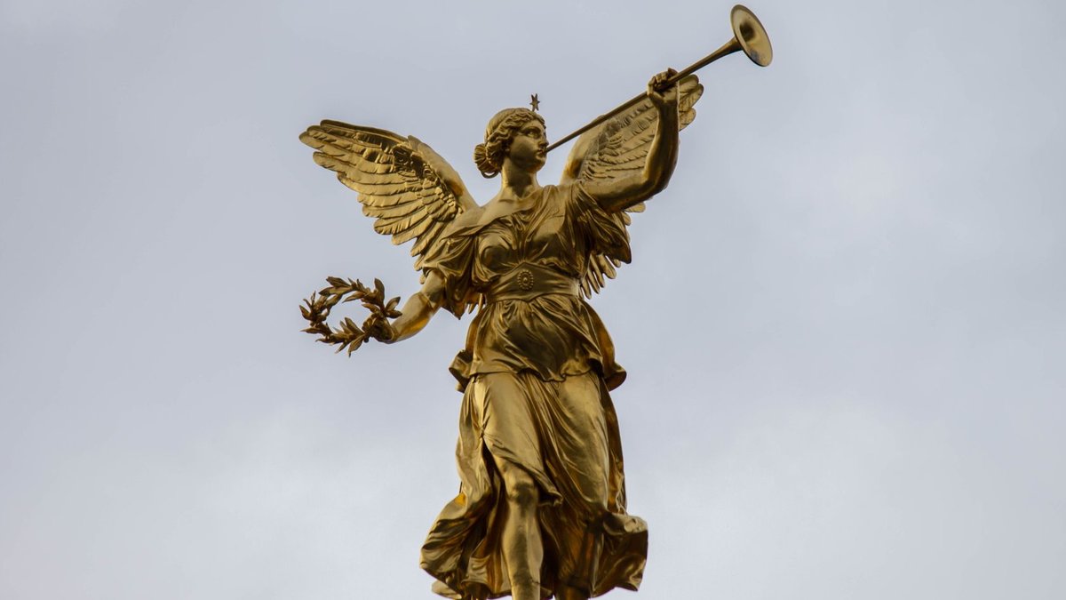 Angel Investors Deliver £2 Billion to UK Start-Ups A majestic golden angel statue with a trumpet, set against a cloudy sky.