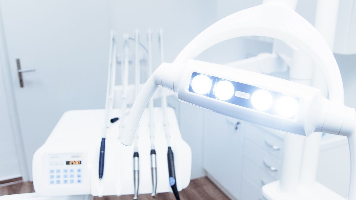 Bright and clean modern dental clinic room with advanced dental equipment.