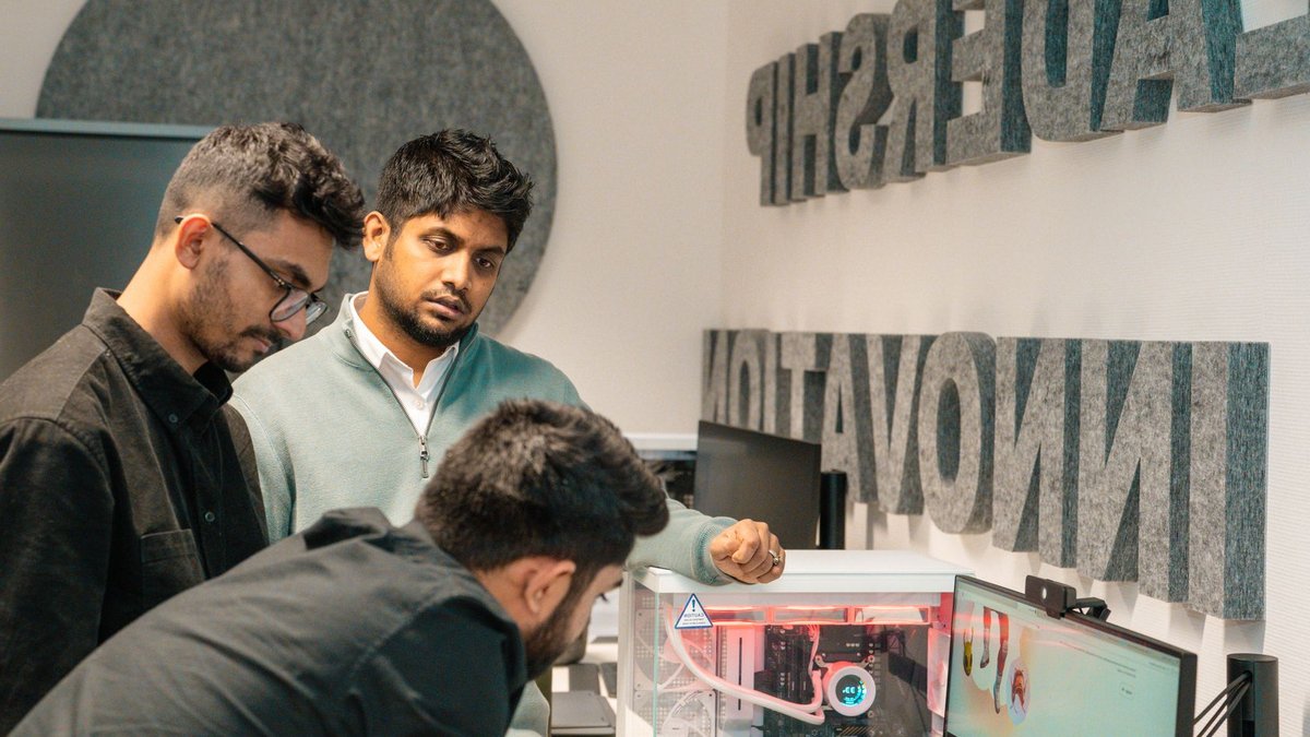 Isgec Heavy Engineering Appoints Mahua Chakrabarty as CHRO Three men collaborate in an office, focusing on tech innovation. Leadership and team dynamics emphasized.