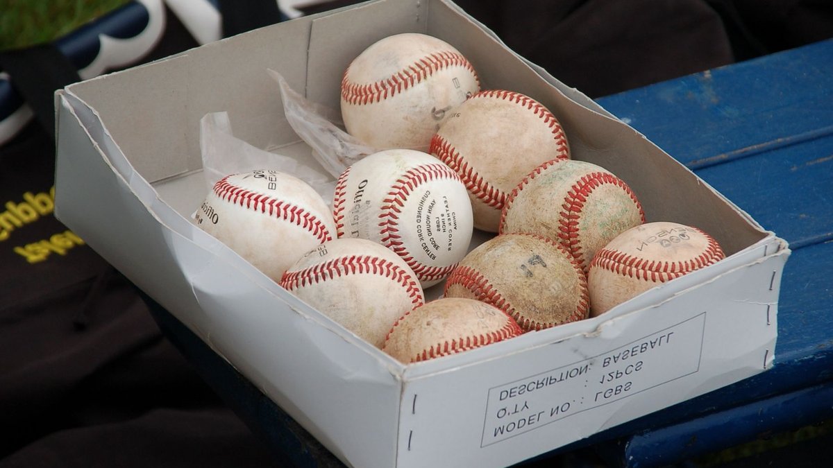 Trump Awards Clemens Presidential Medal of Freedom A box full of used baseballs sitting on a blue bench outdoors, perfect for sports enthusiasts.