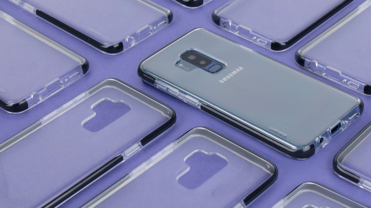 Amazon sale offers Samsung discounts tonight Close-up of a Samsung phone surrounded by transparent cases on a purple surface, showcasing modern technology.