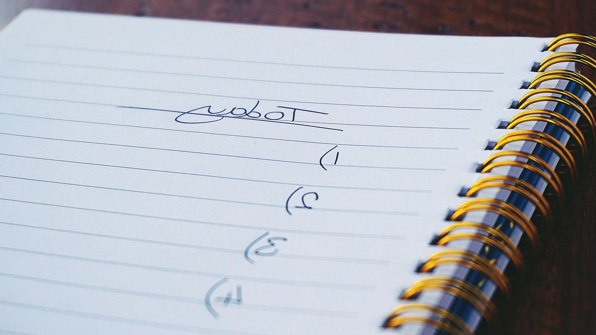 AI assistants replace chatbots as hands-off work helpers A close-up view of a handwritten to-do list on a spiral notebook with numbers for tasks.