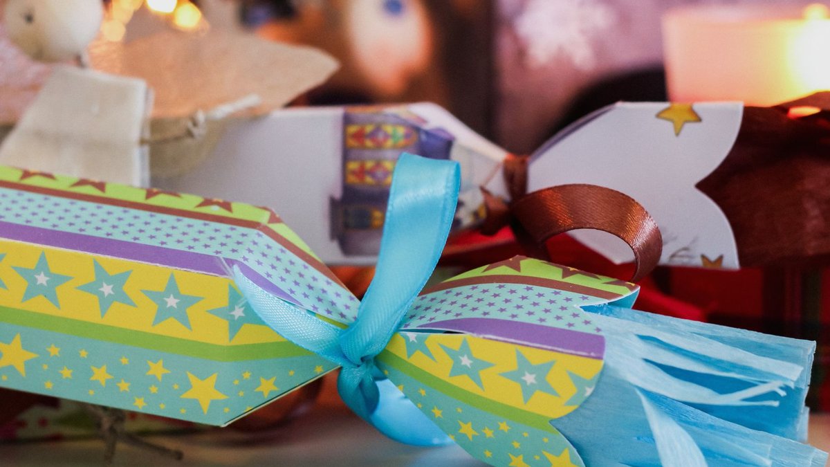 Close-up of vibrant Christmas crackers on a festive holiday table setting.