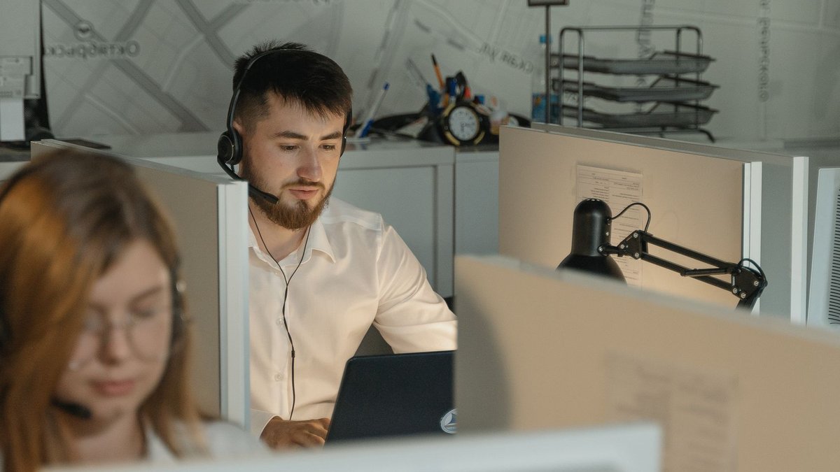 Dedicated call center agents working diligently at their desks in an office.