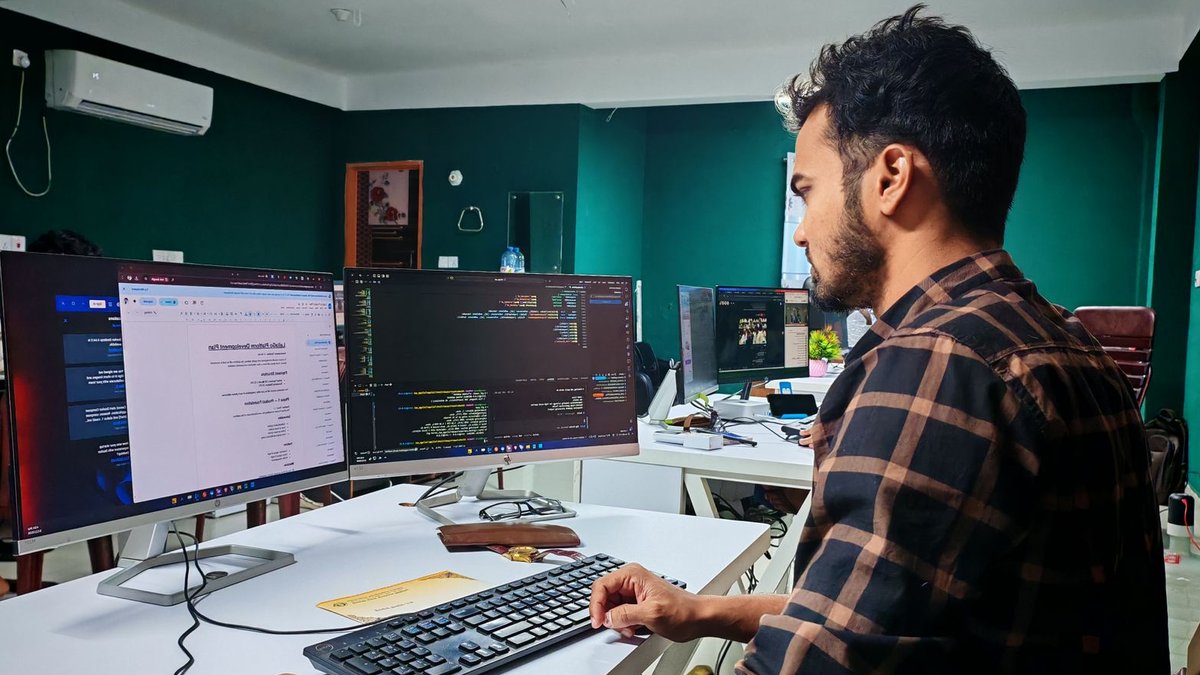 TornadoVM Enables Java on GPUs Software developer coding on dual monitors in a well-lit modern office, focused and engaged.