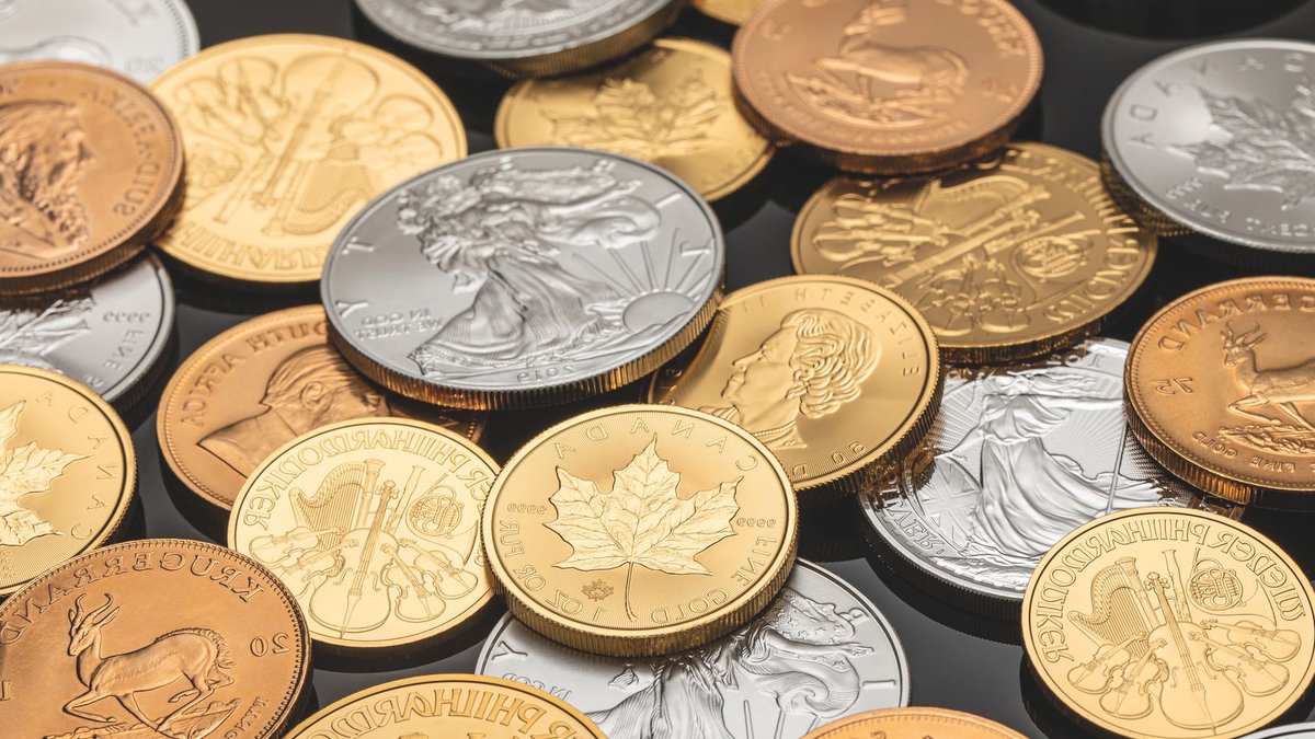 Central banks buy more gold amid uncertainty A detailed view of various gold and silver coins, ideal for financial themes.