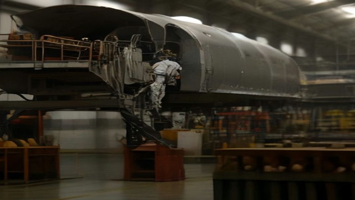 Trump's Reversal Boosts Bombardier Shares Amid Election Focus Aircraft manufacturing plant workers.