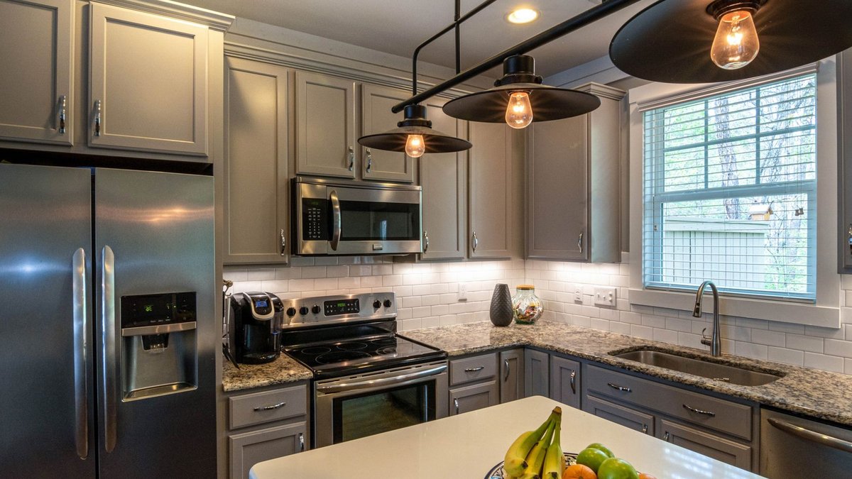 AI Attic Overflow Threatens Corporate Governance Contemporary kitchen featuring a bowl of fruits, stainless appliances, and elegant lighting.