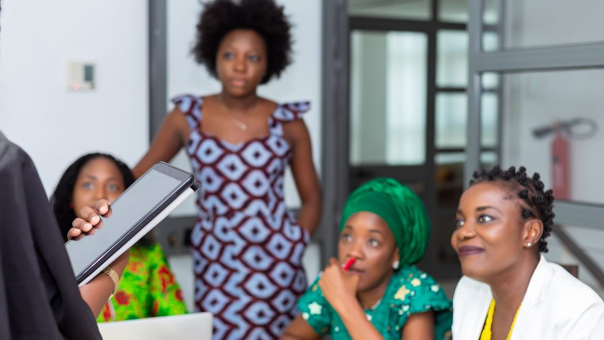 Diverse team of African women collaborating in an office meeting.
