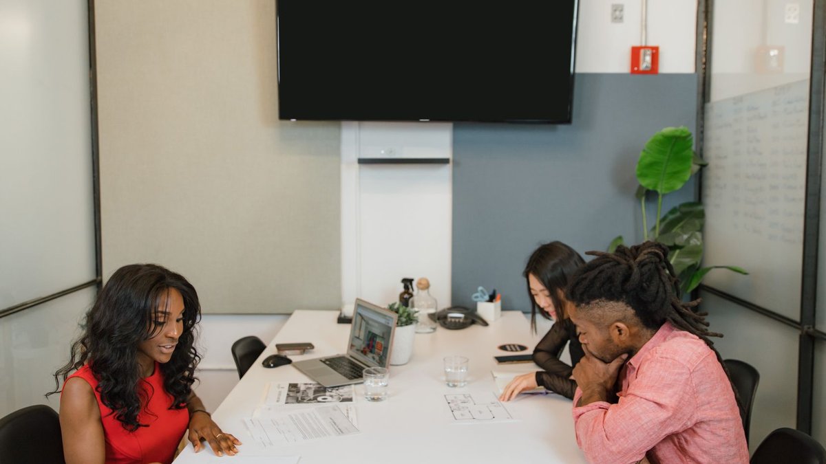 Business professionals having a meeting in a modern office space.
