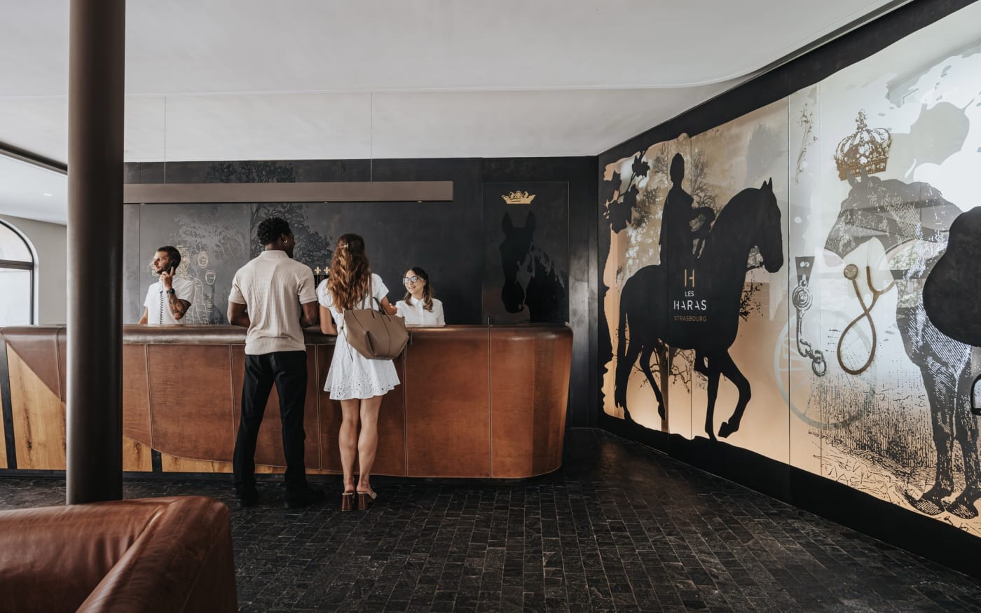 The reception of the hotel Les Haras and its large equestrian fresco
