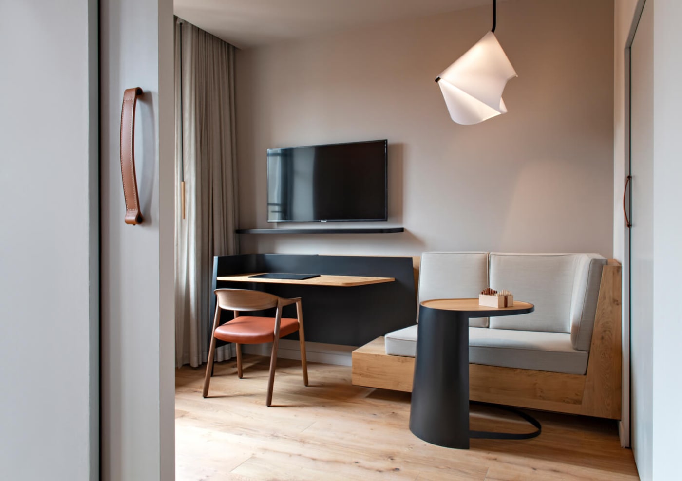 The living room of a Suite at Les Haras with bench and desk