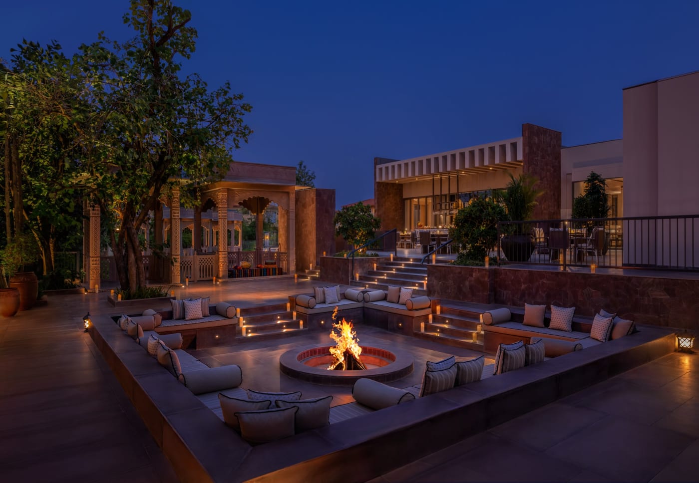 Feu de camp en soirée devant le restaurant Roar au JW Marriott Ranthambore