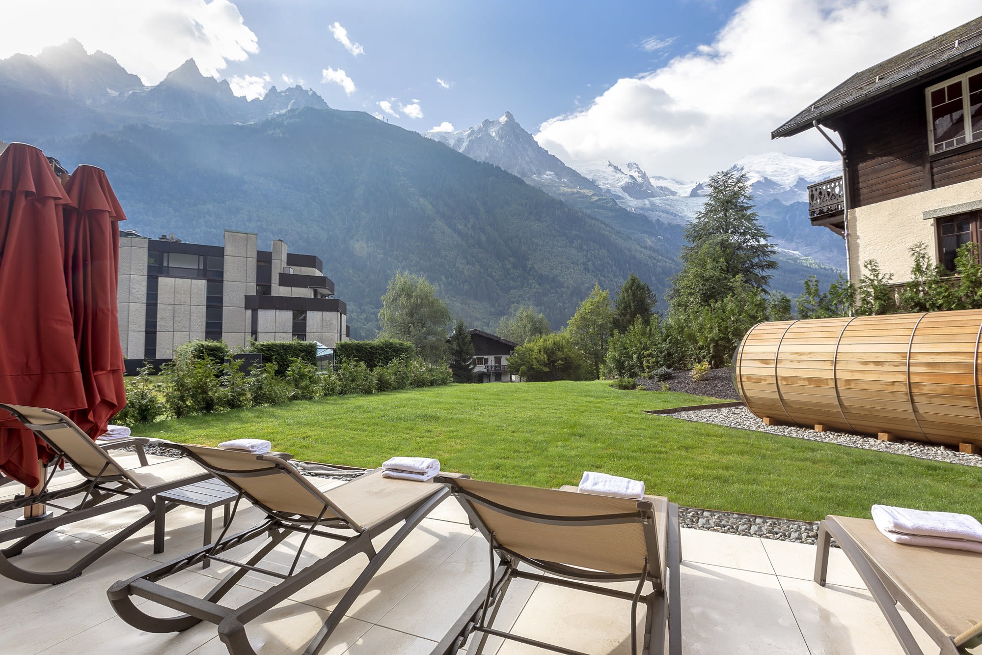 Le sauna tonneau, dans le jardin, face au massif · Chalet Hôtel Le Prieuré