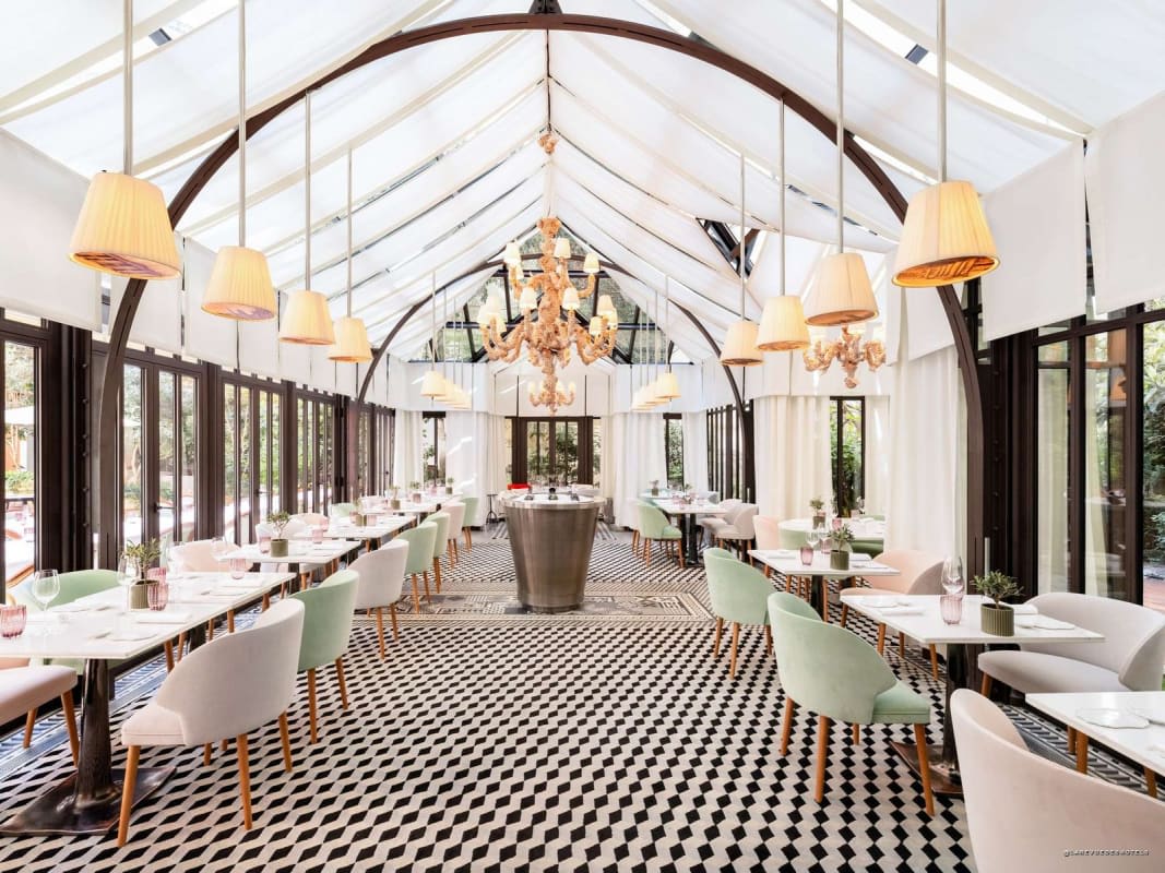 The veranda of Il Carpaccio, Michelin-starred Italian restaurant, checkerboard floor and glass roof