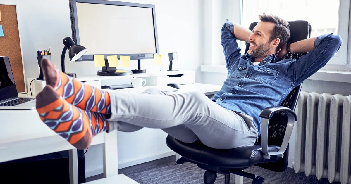 Relaxed man lounging in an office chair