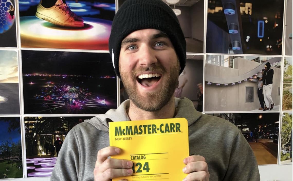 A Jen Lewin Studio employee holds up a McMaster catalogue