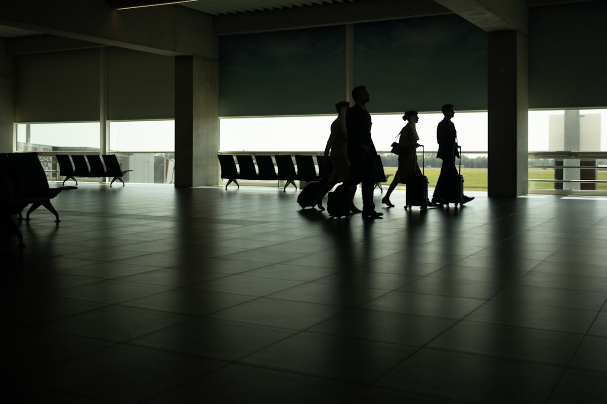 group of people walking through an airport