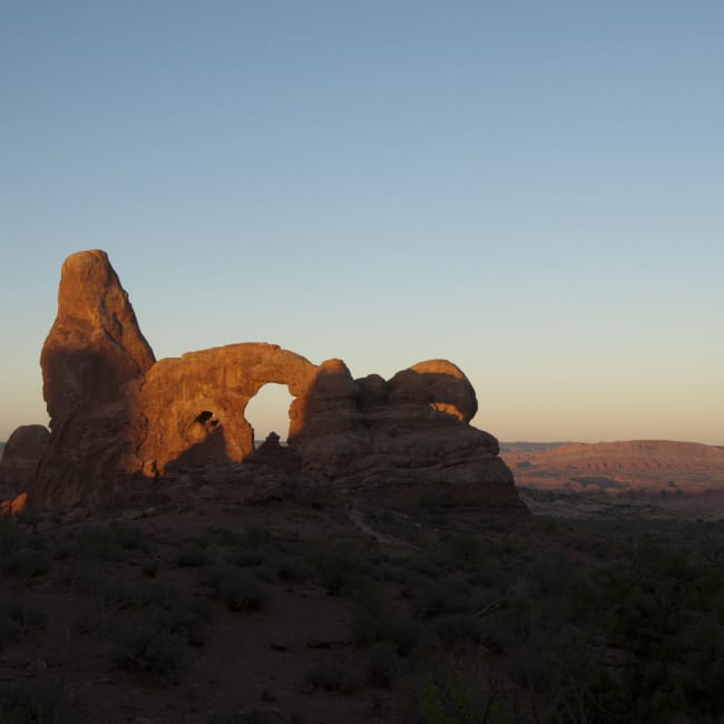 The sun rising over Arches National Park