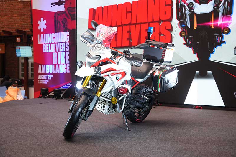 Believers Hospital bike ambulance with medical storage boxes displayed at its launch.