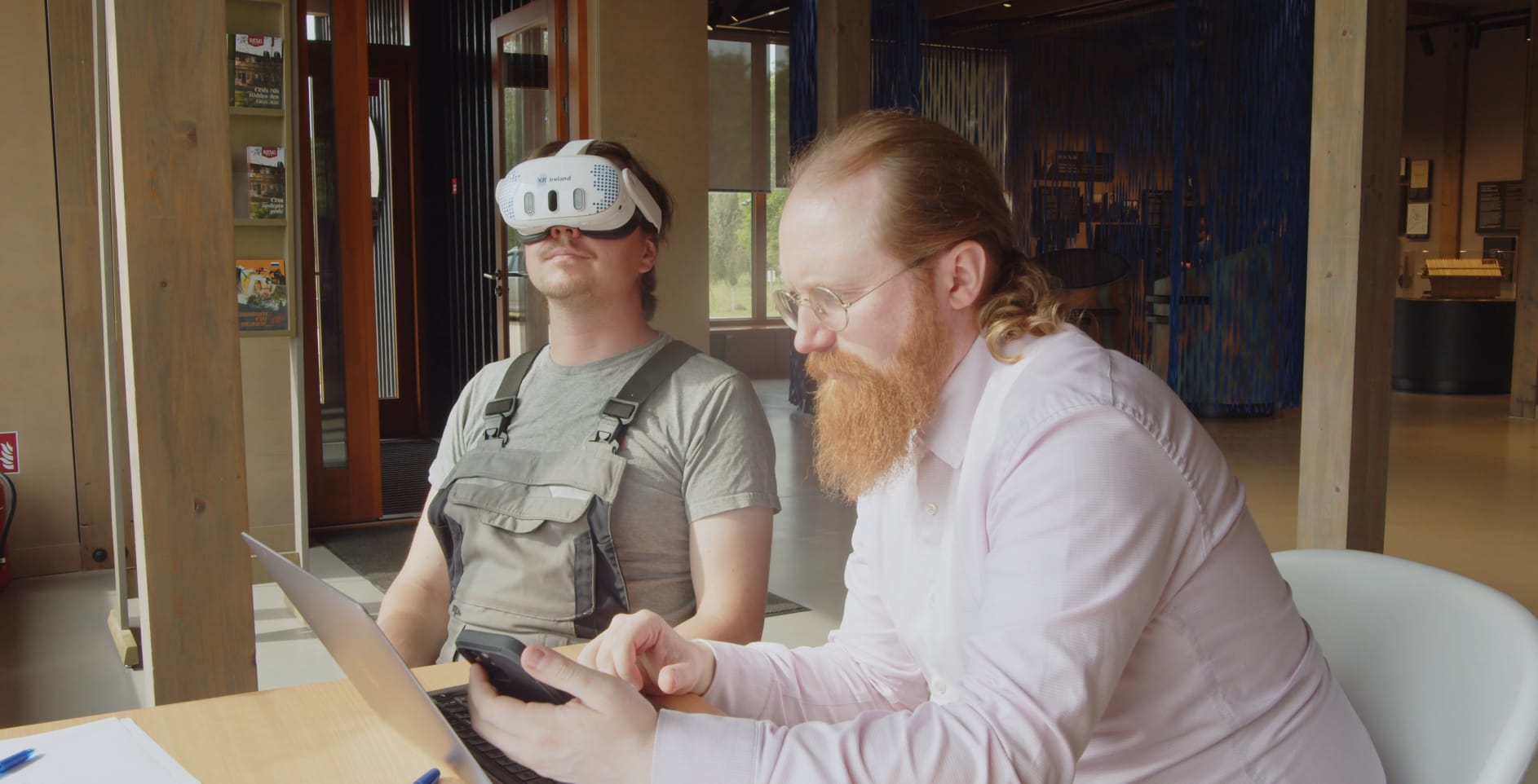 Visitor exploring a 10th-century Latgalian dwelling reconstruction in VR on a Meta Quest 3 headset at Āraiši Ezerpils, July 2025