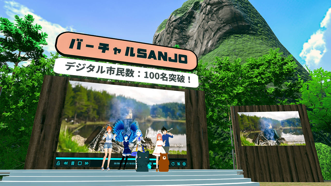 Avatars posing on the entrance stage of the Virtual SANJO VRChat world, under a sign reading 'Virtual SANJO: over 100 digital citizens', with a forested mountain behind