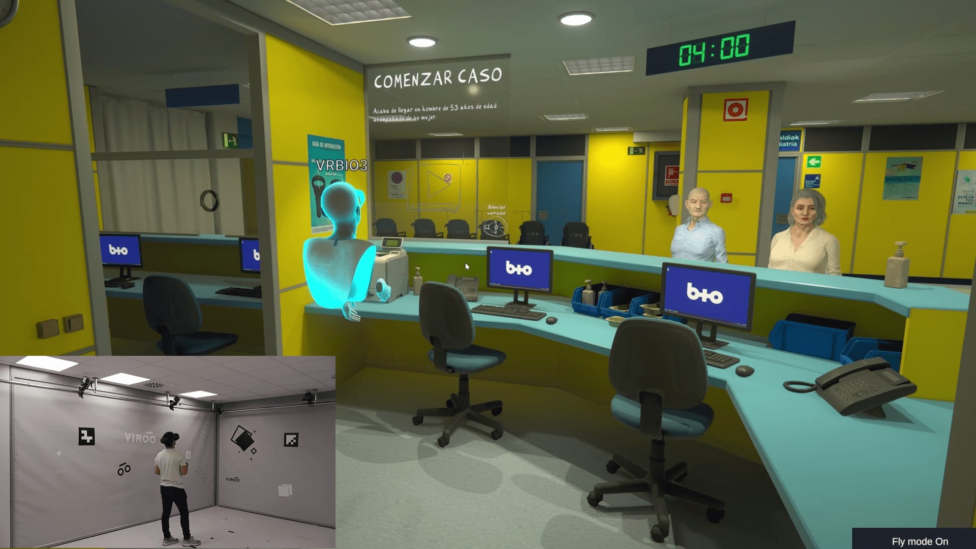 Virtual reality view of the simulated hospital emergency department reception, with a triage case timer and an inset of a trainee in the VIROO tracking room