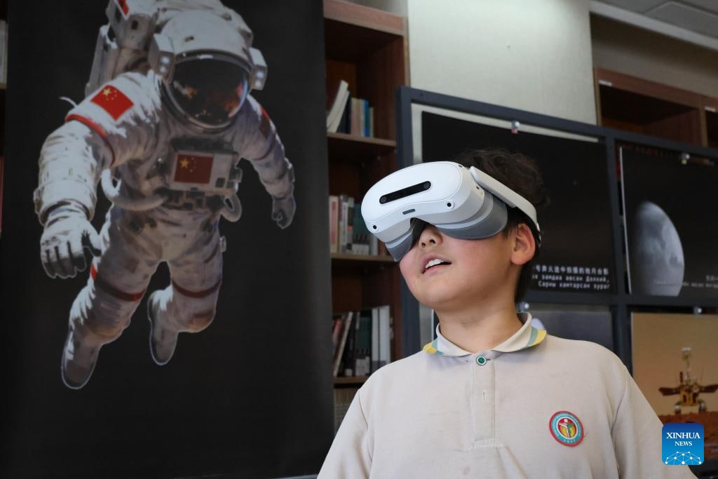 A Mongolian primary school student uses a VR device to experience China's deep-space and lunar exploration technologies during the opening ceremony of a VR exhibition in Ulan Bator, Mongolia, May 29, 2026. (Photo by Bolortsetseg/Xinhua)