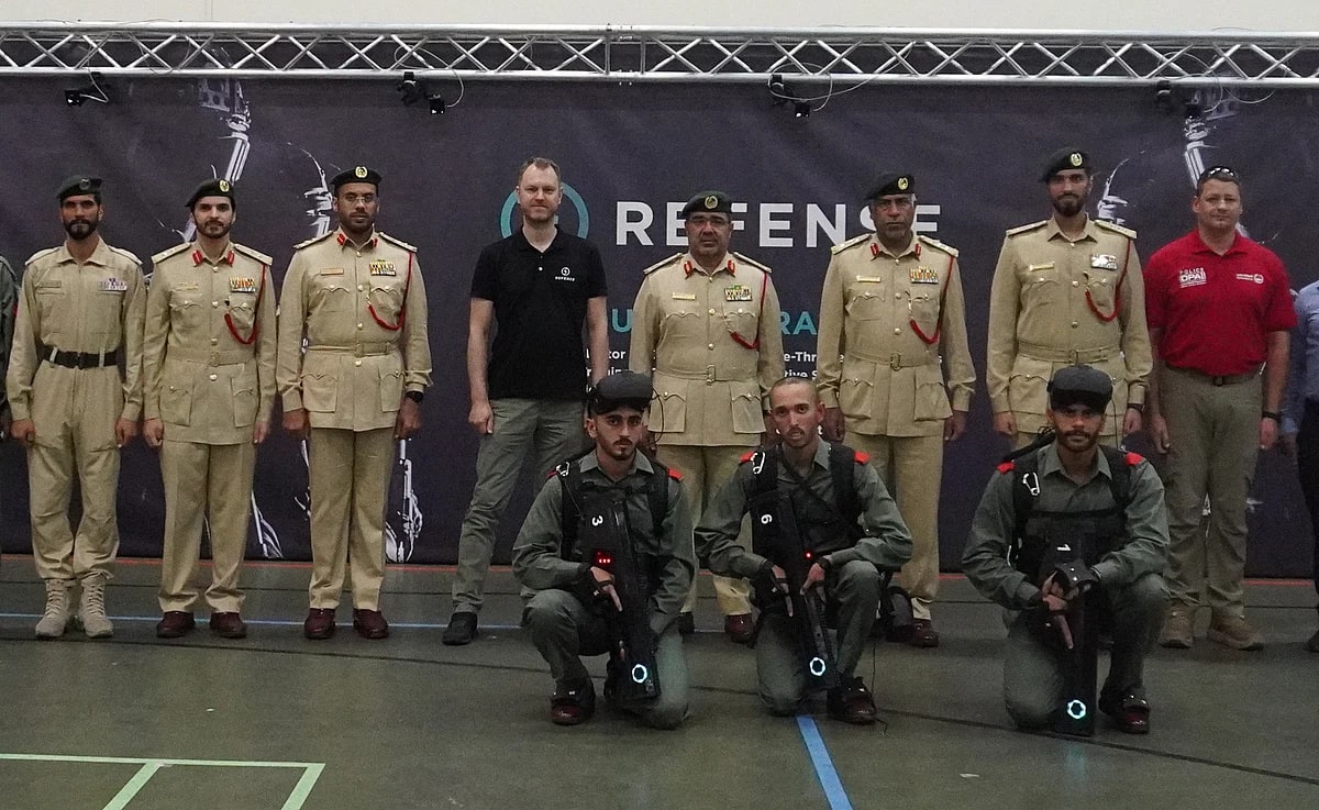 Dubai Police Academy personnel with tracked weapon replicas and numbered player harnesses at the Virtual Field of Operations launch.