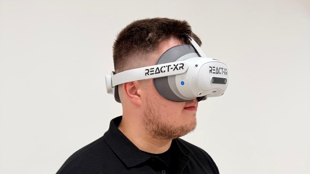 A virtual reality headset worn by a male member of staff