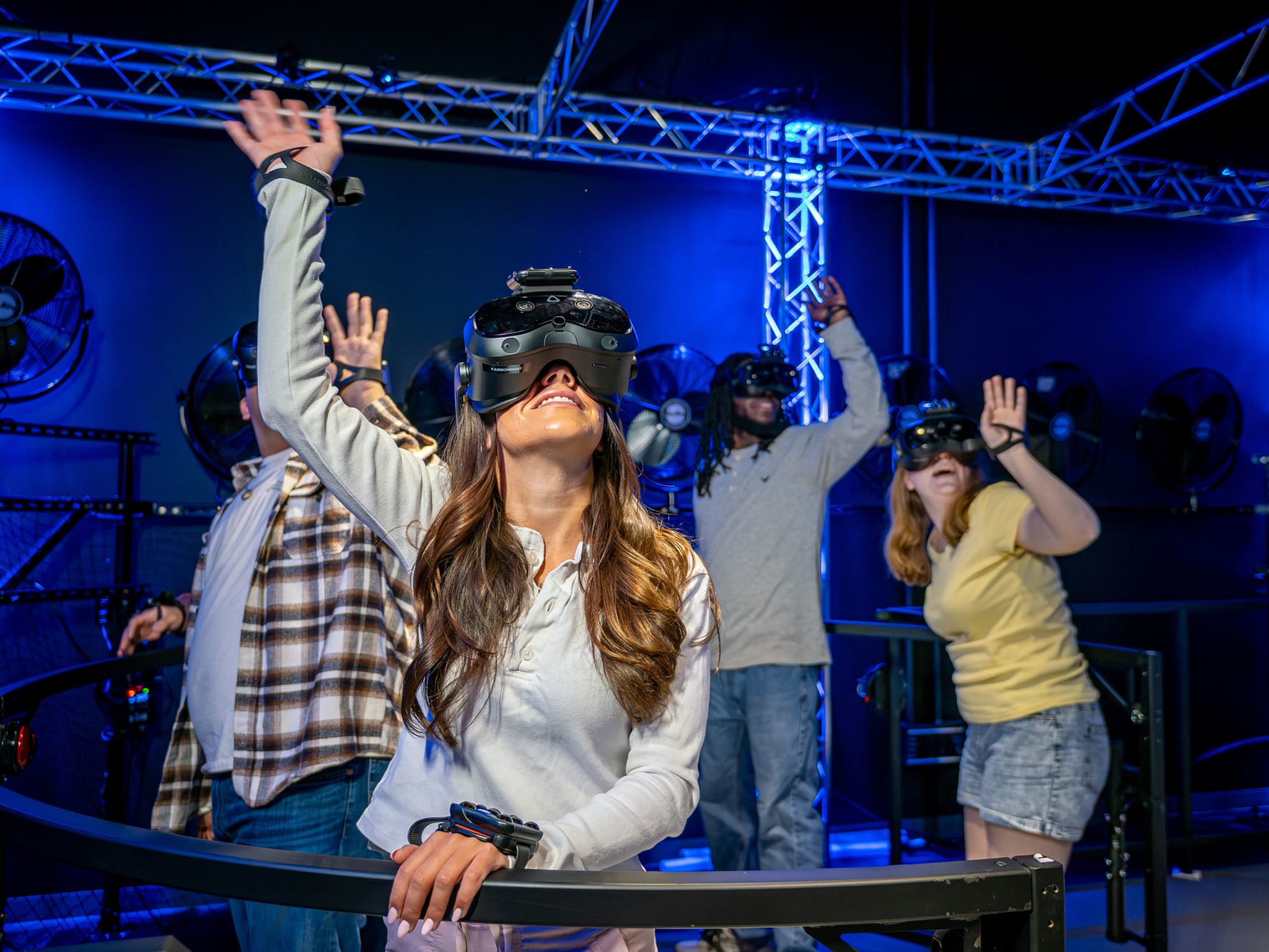 Students seated at bench desks in the Dreamscape Learn classroom wearing VR headsets