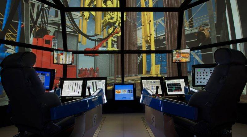 A Drilling Systems simulator: twin driller consoles in front of wraparound screens rendering the rig floor in real time (vendor file image used by the source article, not a photograph of the Petronas installation).