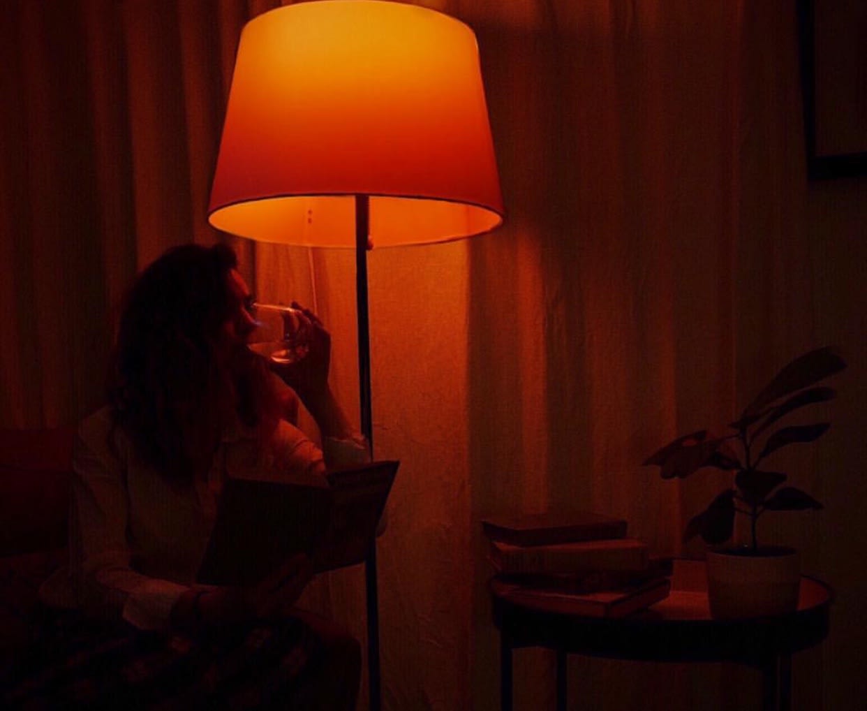 Cinematic urban portrait of a moody subject standing in a rainy city street at night