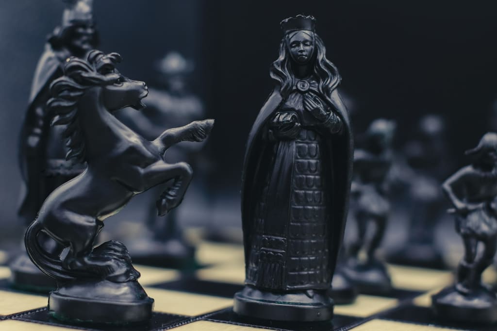 Chess pieces, black king and white queen, rivalry or romance Stock