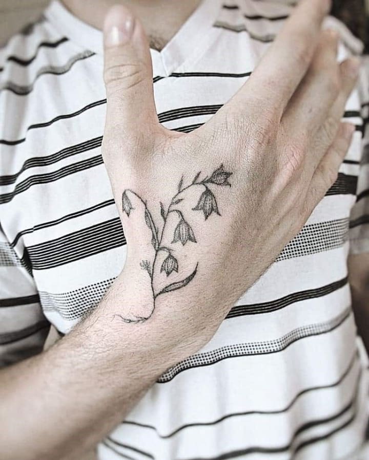 Black Ink Lily Flower Tattoo On Left Upper Wrist