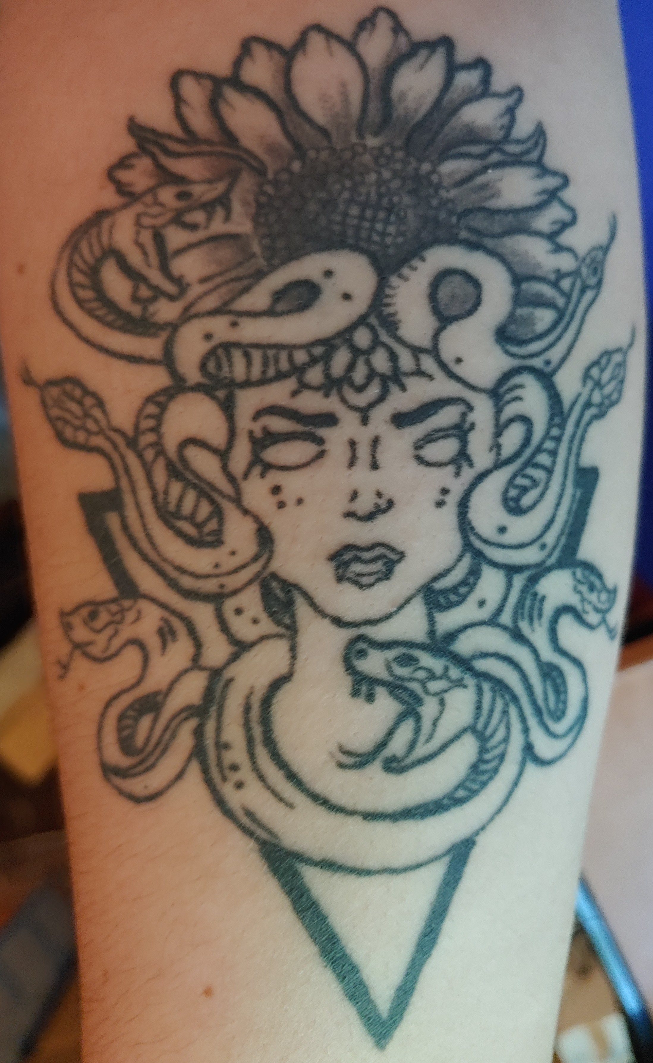 Black and grey Medusa tattoo on the forearm