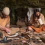 Two people demonstrating flint knapping