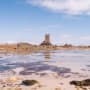 Seymour Tower in distance surrounded by sand